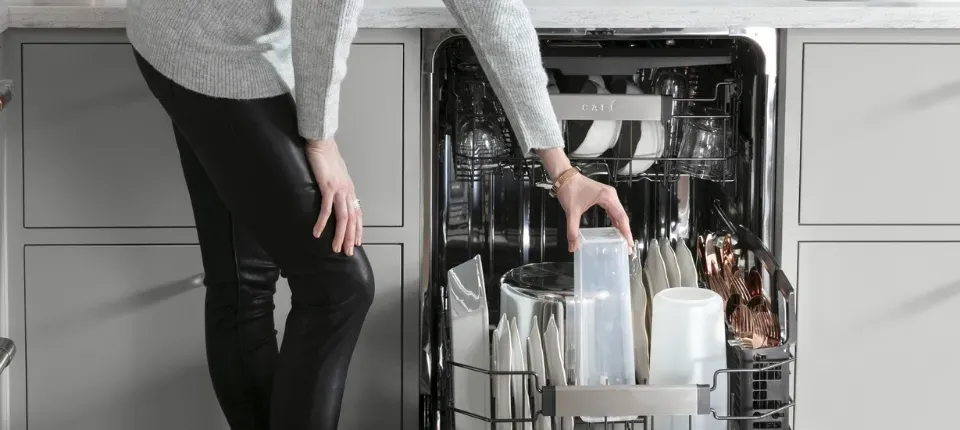 Opened dishwasher full of clean dishes